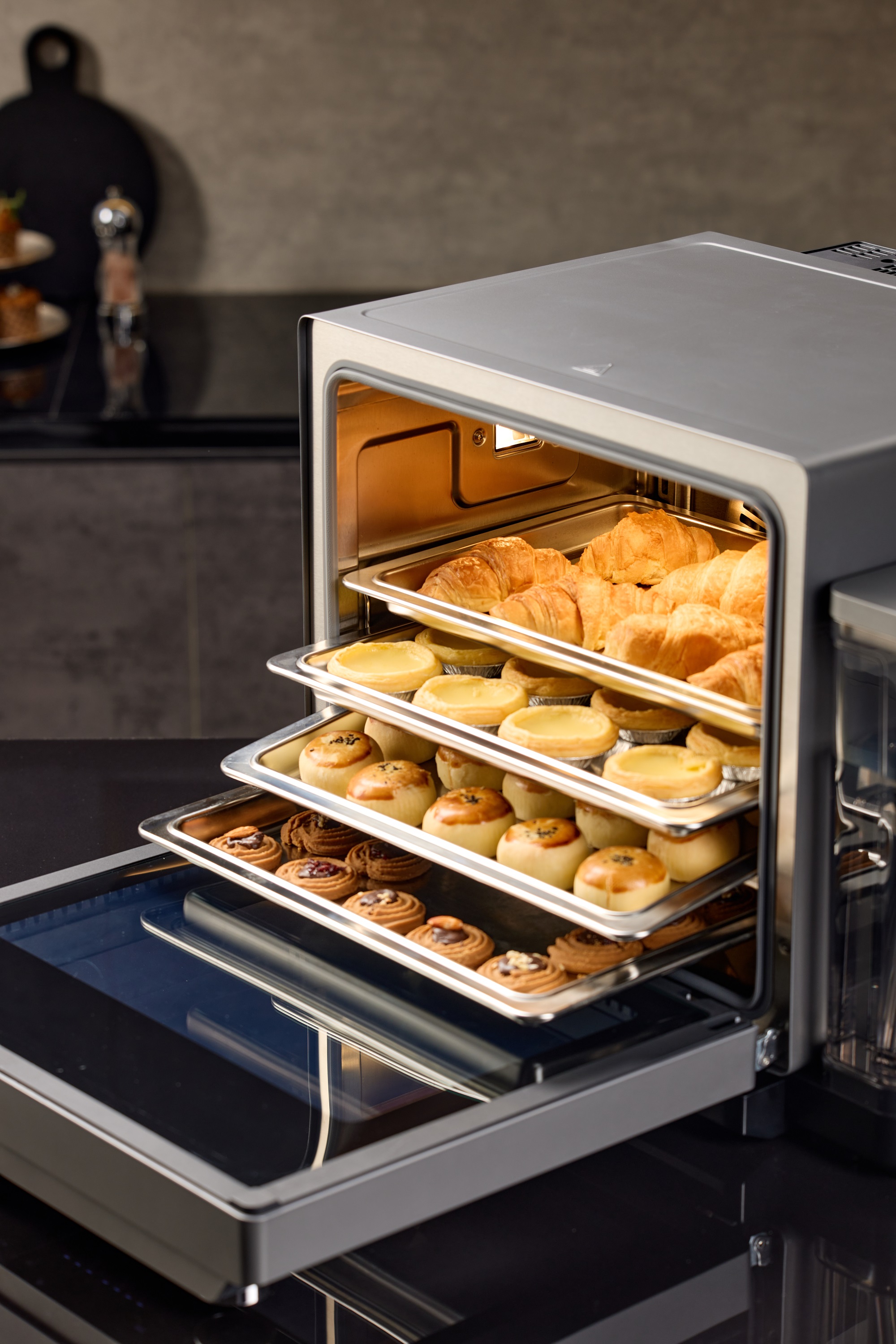 Four loaded racks in the Certainty Oven cavity, mid-bake