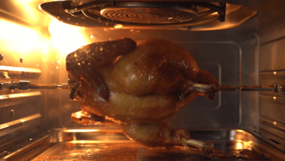 The auto rotisserie turning a roast in the 24L Steam Oven